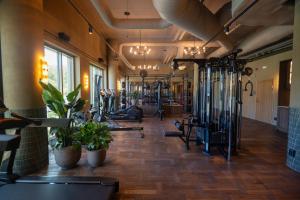 a gym with lots of exercise equipment and plants at The Dock in Södertälje