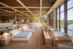 a hotel lobby with couches and tables and windows at The Dock in Södertälje