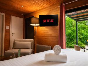 a hotel room with a bed and a chair at Hotel Les Lodges de Vaugrigneuse in Vaugrigneuse