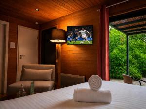a room with a table and a chair and a picture on the wall at Hotel Les Lodges de Vaugrigneuse in Vaugrigneuse