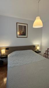 a bedroom with a bed and a picture on the wall at CityLife Torrevieja in Torrevieja