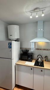 a kitchen with a white refrigerator and a microwave at CityLife Torrevieja in Torrevieja +15 photos