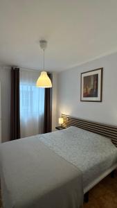 a bedroom with a bed and a lamp and a window at CityLife Torrevieja in Torrevieja