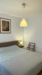 a bedroom with a bed and a light fixture at CityLife Torrevieja in Torrevieja