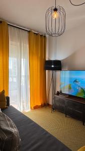 a bedroom with a flat screen tv and a bed at CityLife Torrevieja in Torrevieja
