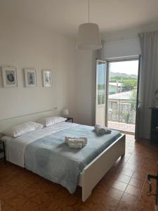 a bedroom with a bed and a large window at Casa Lea - Sperlonga in Sperlonga