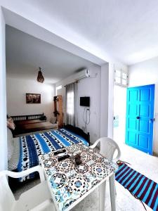 a bedroom with a bed and a table and chairs at Dar Aziz in Sousse