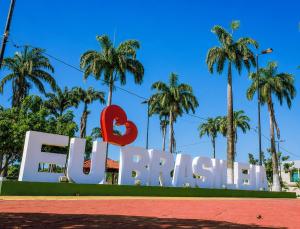 a large sign with palm trees in the background at Studio Brasiléia in Brasiléia +5 photos