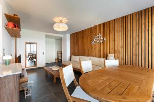 a dining room and living room with a wooden table at L'Astrolabe in Vieux-Fort