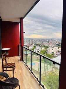 a balcony with a view of a city at monolit residens 6C blok in Tbilisi City