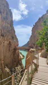a bridge over a river next to a mountain at Casa Eloah in Antequera