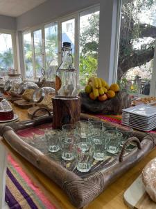 a table with glasses on a tray on a table at Ch Loreto Hotel Boutique in Ciudad de Loreto