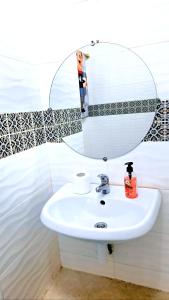 a bathroom with a sink and a mirror at Dar Aziz in Sousse +26 photos
