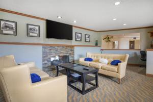 a living room with a couch and a fireplace at Best Western Davison Inn in Davison