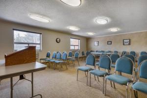 a conference room with blue chairs and a podium at Best Western Davison Inn in Davison +98 photos