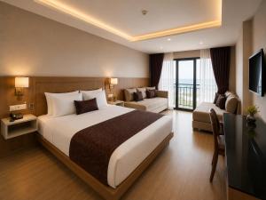 a hotel room with a large bed and a couch at Anemon Kent Trabzon Otel in Trabzon
