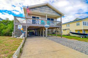 a house with a deck with a flag on it at 4125 - Sea Dawg in Kitty Hawk