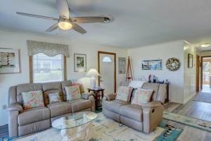 a living room with a couch and a table at 4125 - Sea Dawg in Kitty Hawk