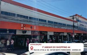 a building with a red and white stripe on it at Shopping 44 Hotel in Goiânia