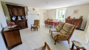 a living room with a couch and a dining room at Gîte de roger in Blond