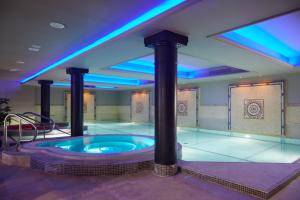 a jacuzzi tub in a room with blue lights at Bunratty Castle Hotel & Leisure Club, BW Premier Collection in Bunratty