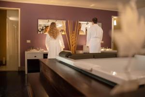 a man and woman in a bathroom looking in a mirror at Casa Cartagena Boutique Hotel & Spa in Cusco