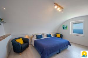 a bedroom with a bed and two chairs at Casa Angelie in Praiano +20 photos
