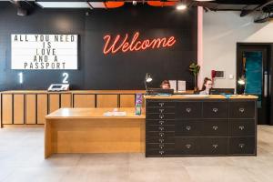 a lobby with two people sitting at a welcome desk at Latroupe Jacobs Inn in Dublin +33 photos