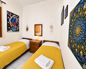 a room with two beds and a mirror at Sun Arise in Porto Rafti