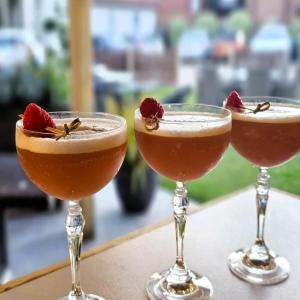 a couple of cocktails sitting on top of a table at Burlington Berties in Sheringham