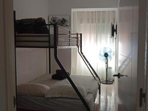 a bedroom with two bunk beds and a window at Alma Brizo Suites in Grao de Castellón