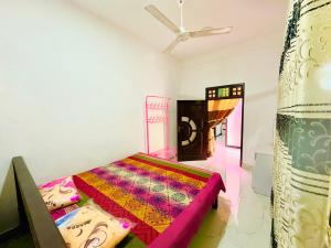 a bedroom with a bed and a ceiling fan at Cleopatra villa in Kattankudi +31 photos