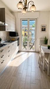 a kitchen with a table and a dining room at MARY HOUSE Central Station Large Apartment in Sondrio