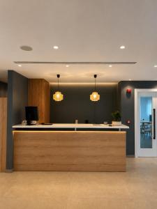 an office with a reception counter with two lights at Tessera Boutique Hotel & Villas Collection in Gouvia +196 photos