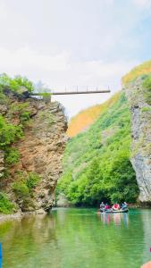 a group of people rafting down a river in a canyon at Vila Darli Peshkopi Dibra in Peshkopi