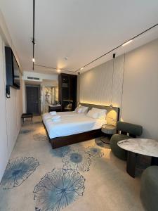 a bedroom with a large bed and a living room at Liberty S Hotel in Novalja +123 photos