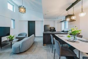 a kitchen and dining room with a large table and chairs at SLL Urban Suites Ebisu in Tokyo