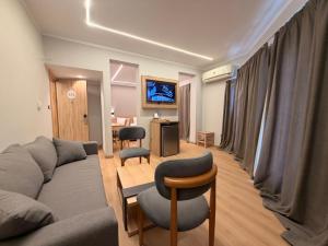 a living room with a couch and a table and chairs at Atlas Hotels in Cairo