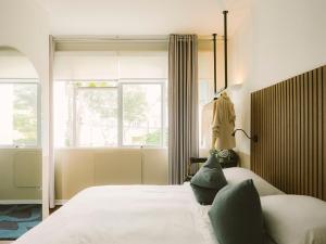 a bedroom with a bed and a window at Fausto by Andean in Lima