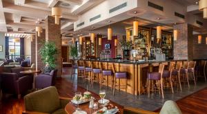 a bar in a restaurant with purple chairs at Mullingar Park Hotel in Mullingar