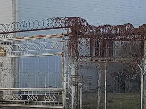 a metal structure with graffiti on the side of a building at Apartamento in Montes Claros