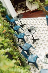 a group of blue chairs and tables on a patio at Fausto by Andean in Lima