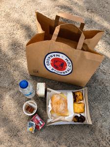 a paper bag with a box of food on the ground at Villa Fatima Hotel by Umbral in Fátima