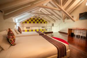 a large bedroom with two beds and a table at Casa Cartagena Boutique Hotel & Spa in Cusco +46 photos