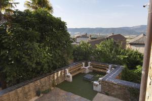 a view of a patio with a table and bench at Casa El Mirador de Jaca in Jaca
