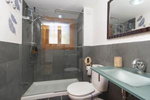 a bathroom with a toilet and a sink and a shower at Casa El Mirador de Jaca in Jaca +42 photos