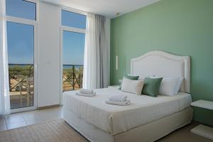 a bedroom with a bed with a view of the ocean at Thalyra in Rethymno +30 photos