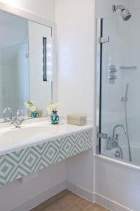 a bathroom with a sink and a shower at St Enodoc Hotel by Paul Ainsworth in Wadebridge +20 photos