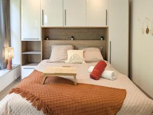a bedroom with a large bed with a table on it at Cocoon studio in Gap