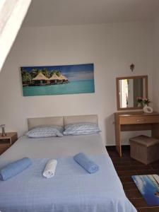 a bedroom with a bed with two pillows on it at stockholm in Bregvija